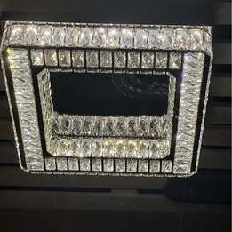 Crystal Chandelier with stainless steel and mirrored finish. 3 colour options. Remote Control.