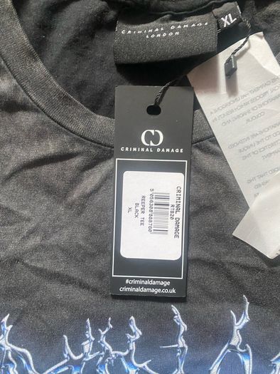 Criminal Damage Men's T-shirt Reaper Graphic Tee has a relaxed fit, short sleeves, a washed black look, and grim reaper graphics on the front.