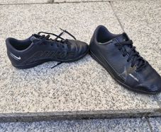 Black Nike Mercurial children's turf or indoor football trainers.