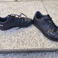 Black Nike Mercurial children's turf or indoor football trainers.