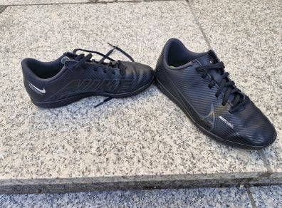 Black Nike Mercurial children's turf or indoor football trainers.