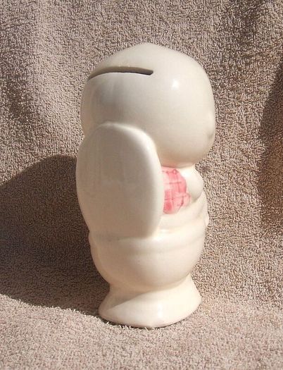 A vintage novelty money box in form of a young child sitting on a toilet (1930s to 1960s)
