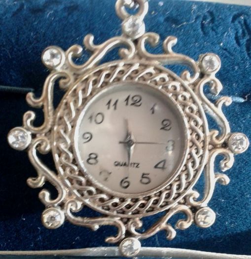 Ladies Quartz Necklace Watch with Filigree Design on Casing and Surrounded by 8 White-Silver Diamante Stones.
