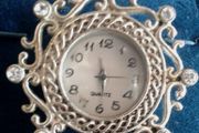 Ladies Quartz Necklace Watch with Filigree Design on Casing and Surrounded by 8 White-Silver Diamante Stones.
