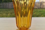 Amber vase on a foot made of pressed glass
