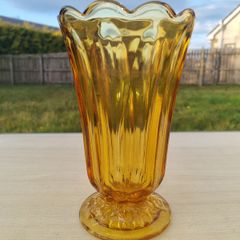 Amber vase on a foot made of pressed glass