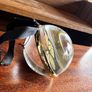 Clear glass bauble or ornament enclosing a butterfly specimen. Image 2