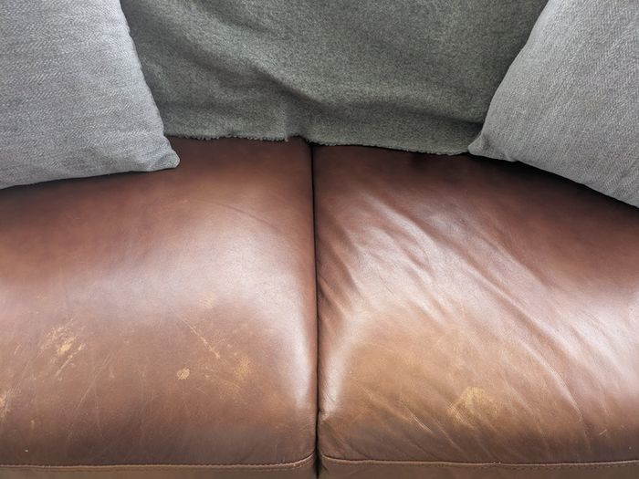 Brown faux-leather two-seater sofa