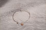 Silver tone adjustable bracelet with charms