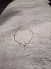 Silver tone adjustable bracelet with charms