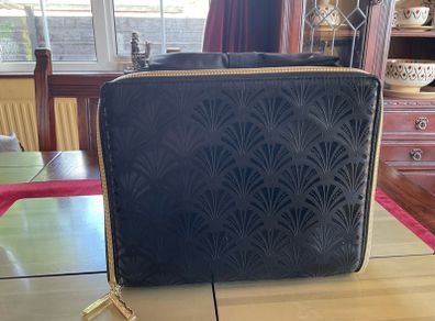 Estee Lauder Vanity case in black with applique style design in the front and a nice bow style handle on top