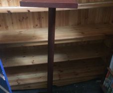 tall wooden display stand on four legs