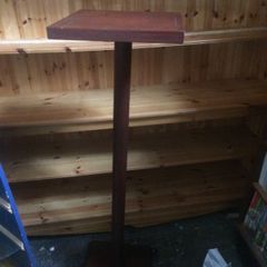 tall wooden display stand on four legs