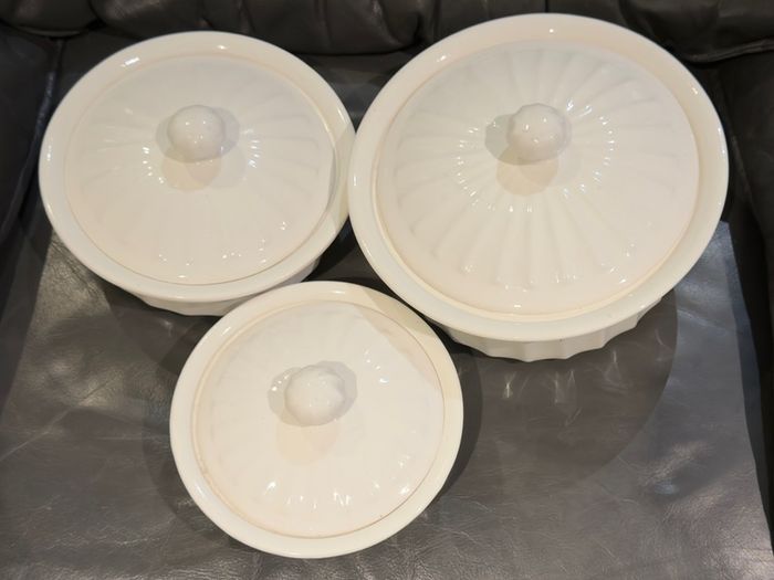 3 white serving bowls with lids.