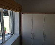 Timer and white wardrobe and bedside locker