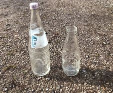 2 glass bottles. Fanta and milk