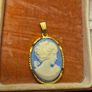 Vintage Cameo Goldtone Pendant on a Blue Background Image 8