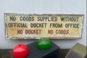large antique hand painted sign,  Goods Supplied without official docket from office, No Docket  No Goods