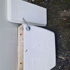 Used ceramic toilet cistern tank