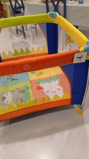 Bright and colorful square baby playpen featuring a cheerful animal safari theme.