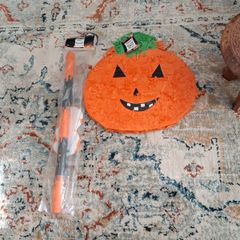 Halloween pumpkin Pinata with stick and mask.