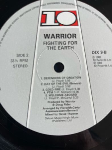 WARRIOR Fighting for the earth original 1985 release with inner lyric sheet vinyl record in near mint condition. Sleeve is vg with just some light wear along top of spine otherwise it would be nm