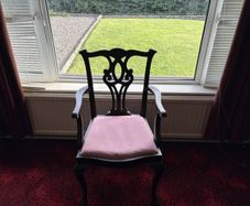 Traditional mahogany carver chair with pink upholstered seat