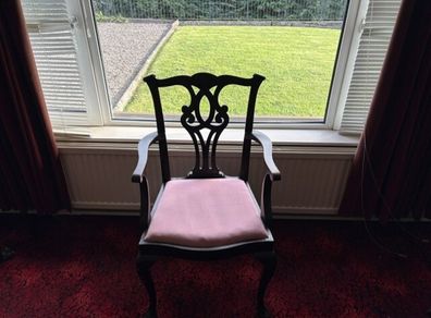 Traditional mahogany carver chair with pink upholstered seat