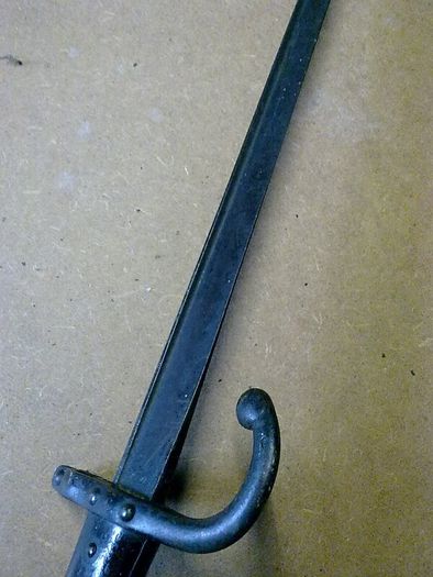 19th century French bayonet with brass and wooden handle.