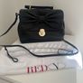 RED V Valentino genuine black leather crossbody bag with large bow and pink interior lining Image 2