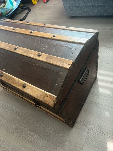 Old travellers chest , lined with super heroes and used as toy chest