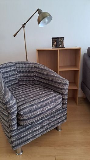Vintage style floor lamp with chair and bookshelf
