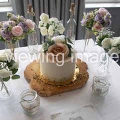 Artificial flowers, floating candles and wood