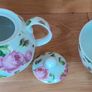 Tea for one: tea pot and cup with rose design on white Image 4