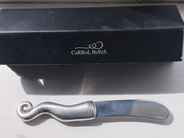 A collectible knife made of polished pewter with a stainless steel blade from Carrol Boyes.