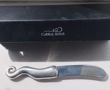 A collectible knife made of polished pewter with a stainless steel blade from Carrol Boyes.