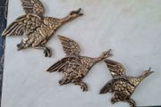 brass flying ducks