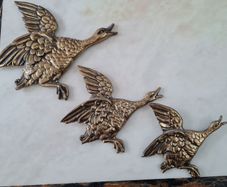 brass flying ducks