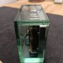 This is an Acctim Hamilton mantel clock made of glass and metal. Image 5