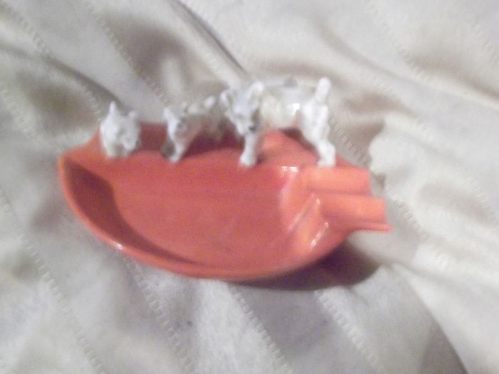 a vintage 1930 ash tray with a dog and two puppys