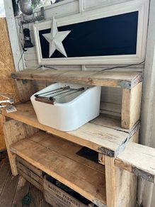 Heavy vintage ceramic basin with a built-in metal rack.