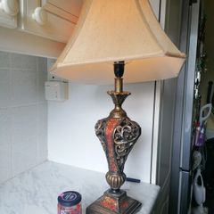 Vintage Tuscan style table lamp with gold-finish resin body with intricate scrollwork and reddish-orange mosaic crackle accents