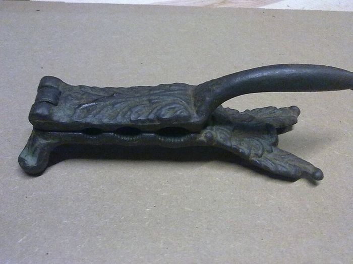 Old ornate cast iron cork presser