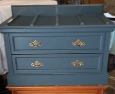 Chest drawers with brass strip suitcase set down
