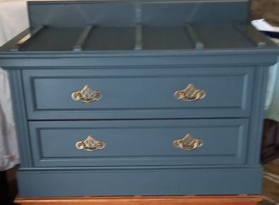 Chest drawers with brass strip suitcase set down