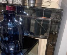 Mirrored furniture with navy velvet accessories