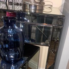 Mirrored furniture with navy velvet accessories