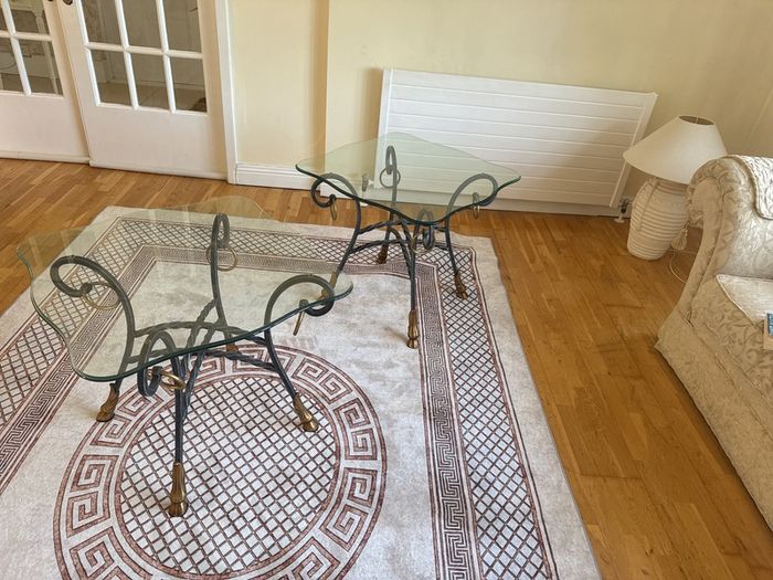 A matching pair of glass tables
