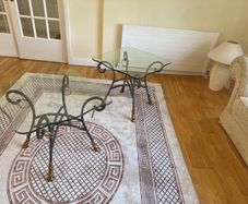 A matching pair of glass tables
