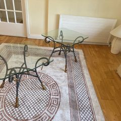 A matching pair of glass tables